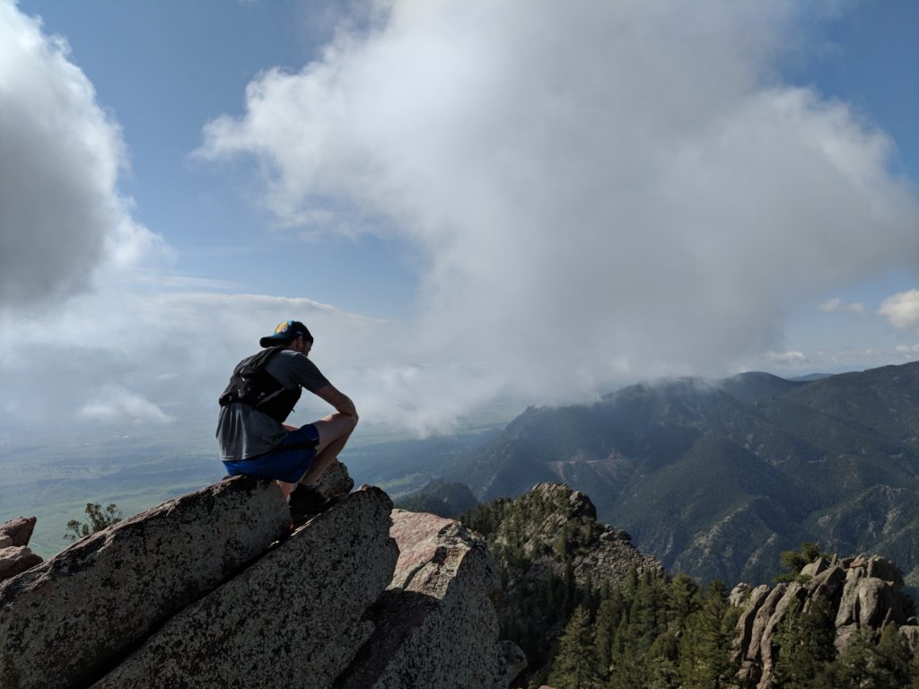 ultra runner sitting on top of a mountain